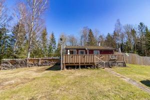 a house in a yard with a fence at BLE853-Holmsjoe-Aelmtamala-338 in Holmsjö