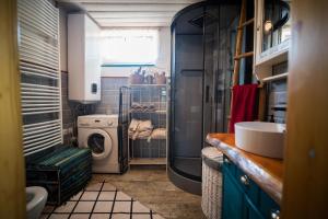 a bathroom with a sink and a washing machine at Drevenička Modruška in Malý Čepčín