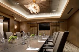 a conference room with a long table and a chandelier at Archer Hotel Napa in Napa