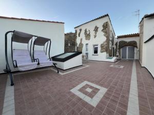 a patio with a bench on the side of a building at La Dimora Della Volpe in Calice Ligure