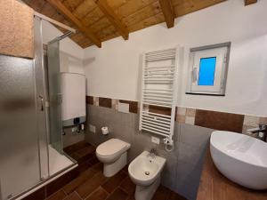 a bathroom with a toilet and a sink at La Dimora Della Volpe in Calice Ligure +35 photos
