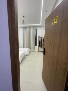 a door to a bedroom with a bed in a room at Hotel kairouan in Fez +3 photos