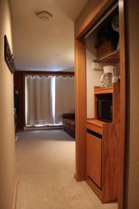 a hallway of a hotel room with a living room at Mountain Adventure Basecamp + Hot Tubs in Winter Park