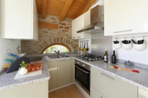 a kitchen with white cabinets and a counter top at Belmonte Terrazzo in Pianello Del Lario