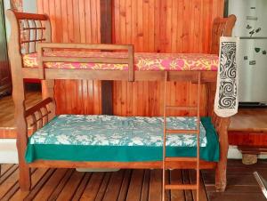 a couple of bunk beds in a room at Oasis nature et cascade privée in Atihiva
