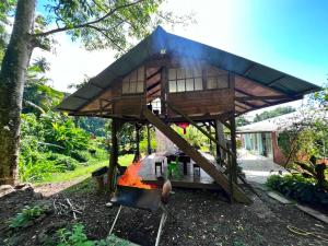 a small tree house with a roof at Oasis nature et cascade privée in Atihiva