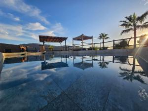 a swimming pool with a view of the sky and palm trees at Finca 3R in Málaga
