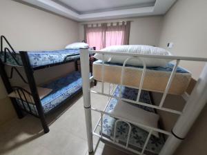 two bunk beds in a room with a window at Oasis Pueyrredón in Rodeo del Medio +31 photos