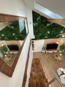 an image of a building with plants on the walls at Le Perchoir de Linas, filet suspendu, appartement cosy in Linas