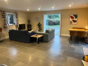 a living room with two couches and a table at Chiltern Studio in Wendover +23 photos