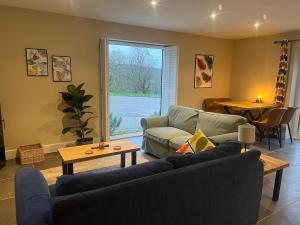 a living room with a couch and a table at Chiltern Studio in Wendover