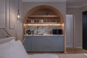 a kitchen with a sink and a counter at Mountain Pine Luxury Suites in Florina