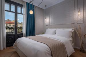 a bedroom with a large bed and a window at Mountain Pine Luxury Suites in Florina