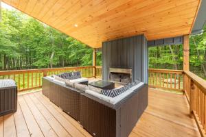 an outdoor deck with chairs and a fireplace at Afterglow by Railey Vacations in Oakland