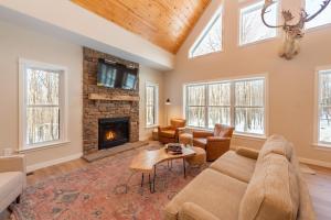 a living room with a couch and a fireplace at Afterglow by Railey Vacations in Oakland