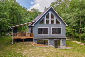 a house with a deck in the woods at Afterglow by Railey Vacations in Oakland