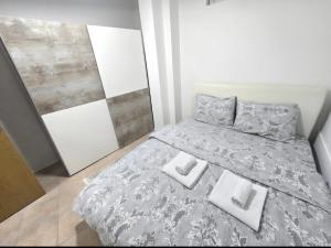 a bedroom with a bed with two pillows on it at Iskra Apartment 2 in Kragujevac