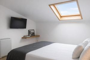 a bedroom with a bed and a television on the wall at Hotel Ristorante Poseidonia in Sapri