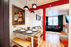 a living room with a table and a couch at The Simms Suite in Worthing