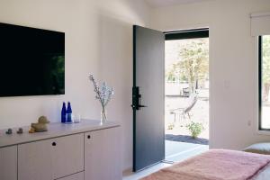 a bedroom with a sliding door to a patio at Three Ducks in Westhampton