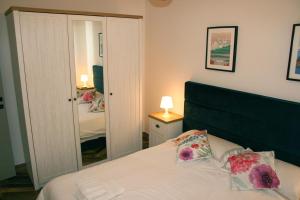 a bedroom with a bed and a mirror at Two bedroom loft apartment with outdoor area, served with lift in Rabat