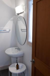 a bathroom with a sink and a mirror at Fieldstone Guesthouse in Clearwater