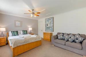 a bedroom with a bed and a couch at 2 Bed in Bamburgh oc-gd1273 in Bamburgh