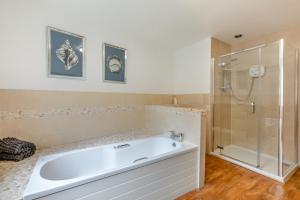 a large bathroom with a tub and a shower at 2 Bed in Bamburgh oc-gd1273 in Bamburgh +16 photos