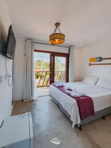a bedroom with a bed and a large window at Pousada Vila Bella Icaraí in Icaraí +90 photos