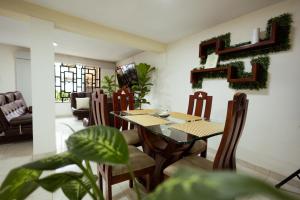 a dining room with a table and chairs at Casa Lilí Guaduas in Guaduas