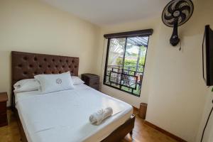 a bedroom with a large bed and a window at Casa Lilí Guaduas in Guaduas +45 photos