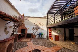 a courtyard with a brick fireplace and a building at Casa Lilí Guaduas in Guaduas