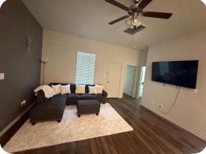 a living room with a couch and a flat screen tv at Beautiful modern 3 bed 2 bath in Fort Worth