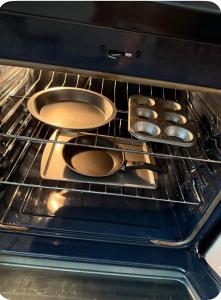 four pans are sitting in an oven at Beautiful modern 3 bed 2 bath in Fort Worth +25 photos
