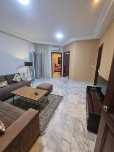 a living room with a couch and a table at Luxe studio tunisia mall lac 2 in Tunis
