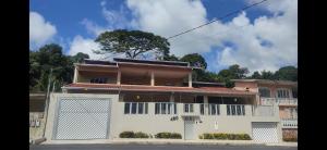 a large white house with a garage at Base Luz na Floresta in Manaus +14 photos
