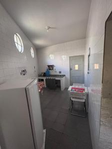 a kitchen with a sink and a refrigerator at Pousada Mara Mar Niterói in Niterói +6 photos