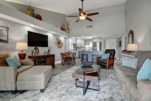 a living room with a couch and a table at PL645 - Bay Hill Fairway - Alice Lodging in Palm Desert
