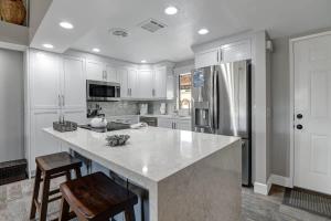 a kitchen with white cabinets and a large kitchen island at PL645 - Bay Hill Fairway - Alice Lodging in Palm Desert