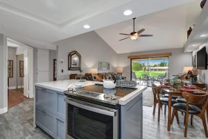 a kitchen and dining room with a stove top oven at PL645 - Bay Hill Fairway - Alice Lodging in Palm Desert