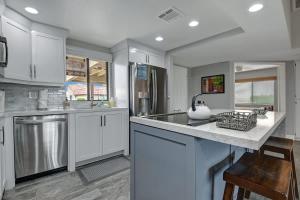 a kitchen with white cabinets and stainless steel appliances at PL645 - Bay Hill Fairway - Alice Lodging in Palm Desert +31 photos