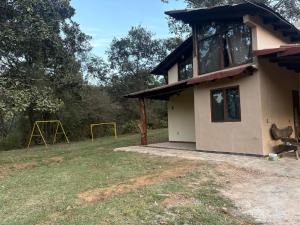 a small house with a playground in the yard at Cabaña lagunita in Sabinas +4 photos