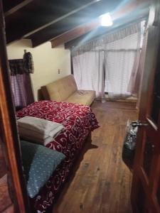 a bedroom with a bed and a chair in it at Cabaña lagunita in Sabinas