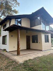 a house with a tree in front of it at Cabaña lagunita in Sabinas
