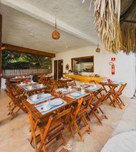 a dining room with wooden tables and chairs at Pousada Vila Bella Icaraí in Icaraí