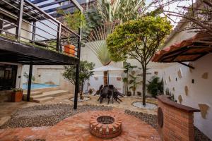 a courtyard with a pool in a building with trees at Casa Lilí Guaduas in Guaduas