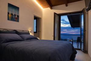 a bedroom with a bed and a view of the ocean at IL CAMBUSIERE nature relais in Ortona