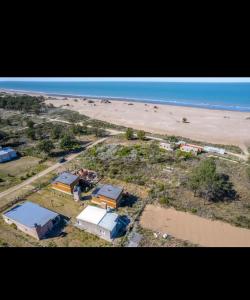 an aerial view of a beach with houses and the ocean at Village Pehuen in Balneario Pehuén-Có
