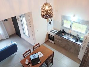 an overhead view of a kitchen with a table and a dining room at Village Pehuen in Balneario Pehuén-Có