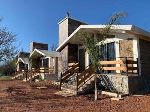 a house with a palm tree in front of it at Cabañas Hacienda Real in Zacatlán +2 photos